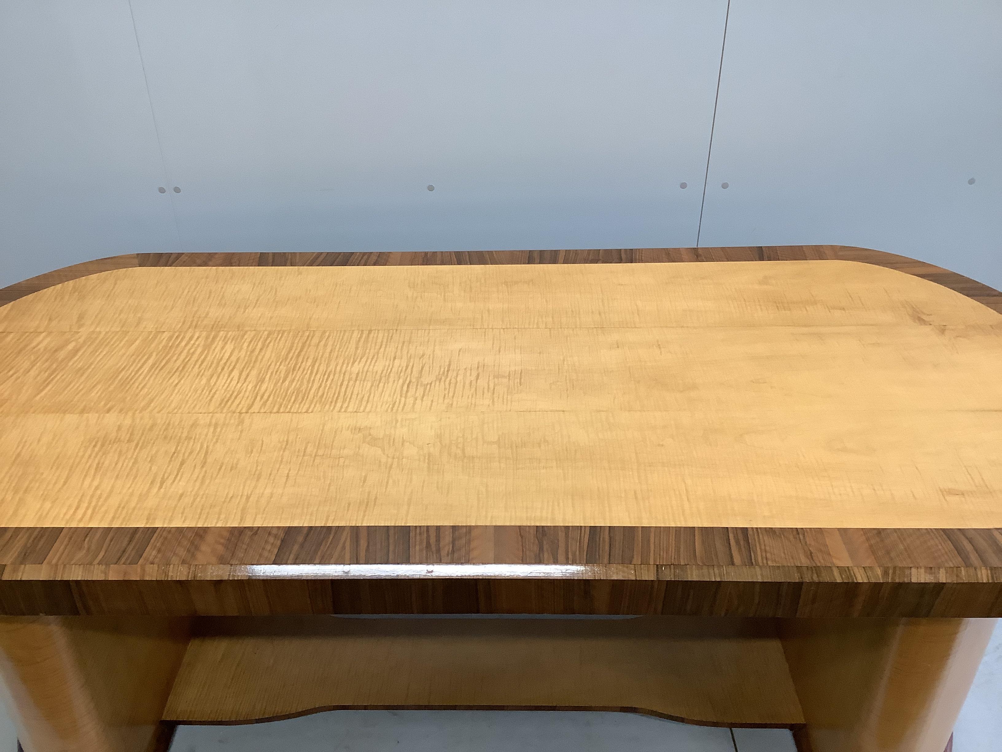 An Art Deco walnut banded satinwood dining or centre table, width 220cm, depth 98cm, height 80cm